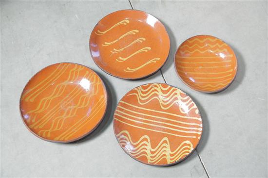FOUR GREG SHOONER REDWARE PLATES.