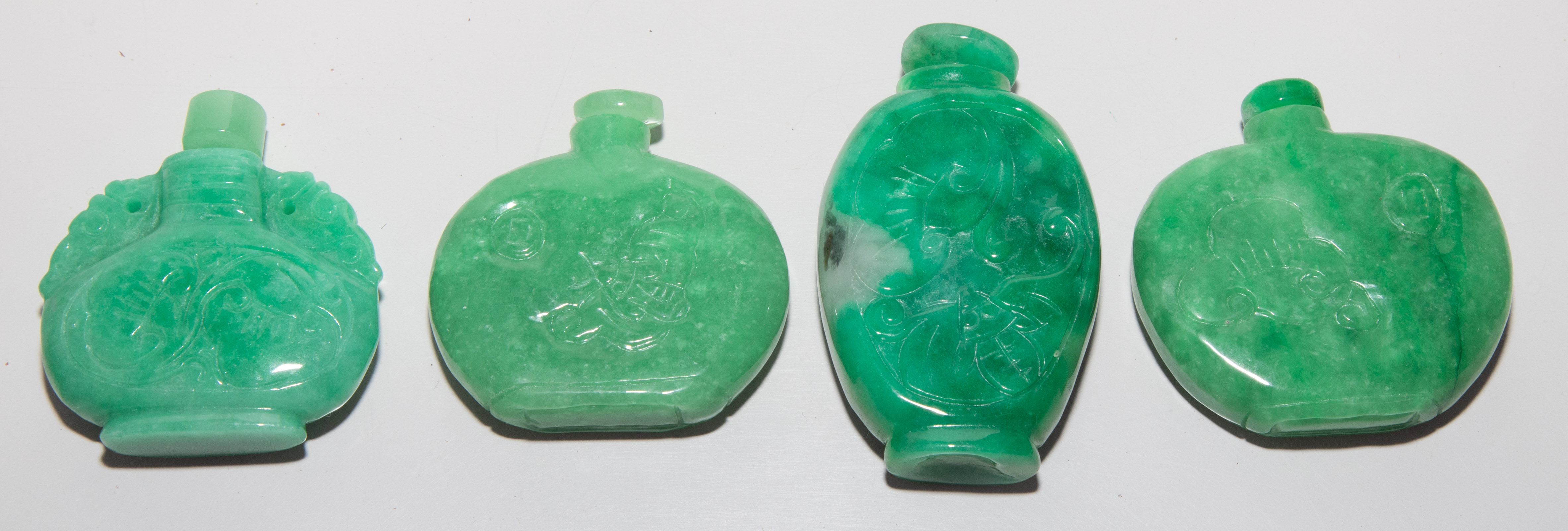 FOUR HARDSTONE SNUFF BOTTLES .