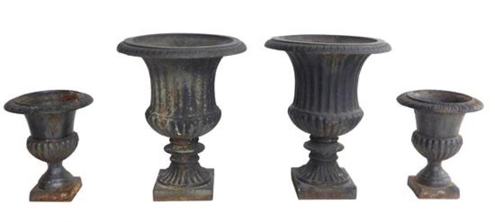 FOUR IRON GARDEN URNS, TWO SIZES IN