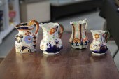 FOUR IRONSTONE CHINA PITCHERS.