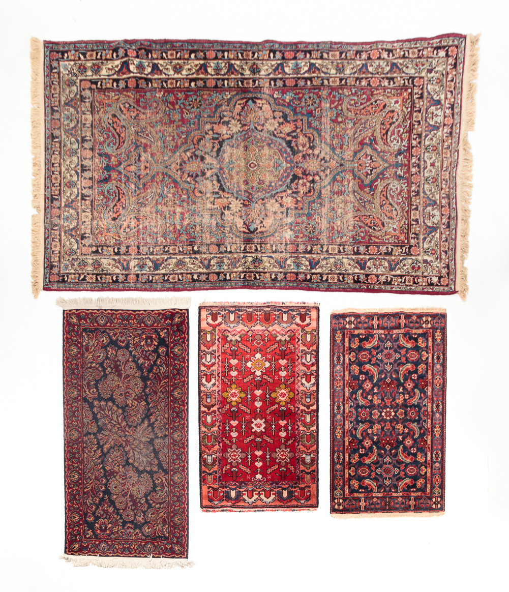 FOUR ORIENTAL RUGS. Twentieth