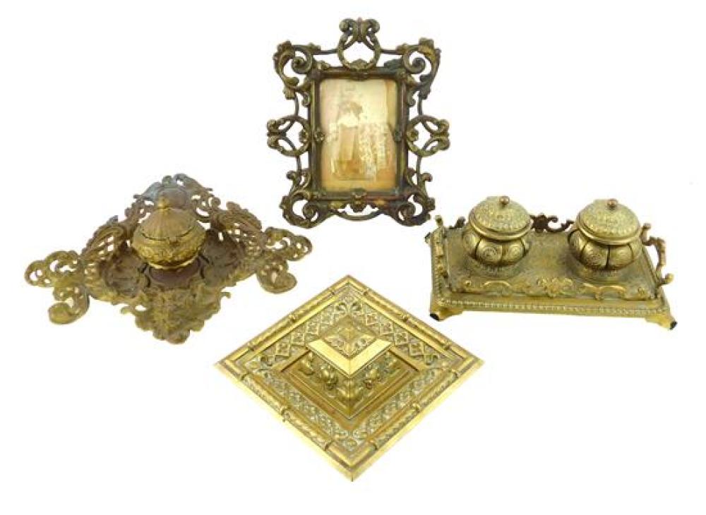 FOUR ORNATE CAST METAL INKWELLS AND