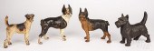 FOUR PAINTED CAST IRON DOG DOO