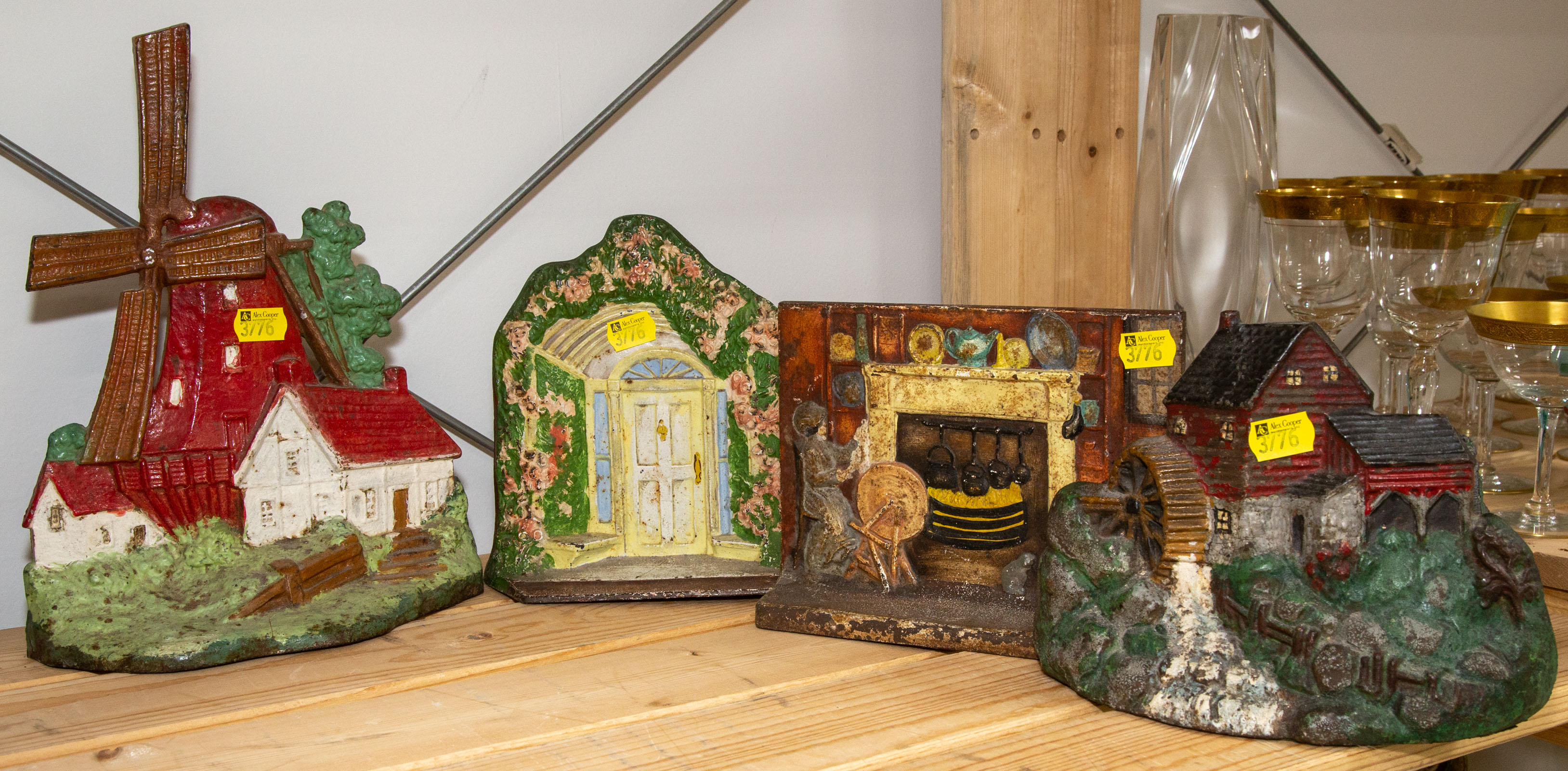 FOUR PAINTED CAST IRON DOOR STOPS