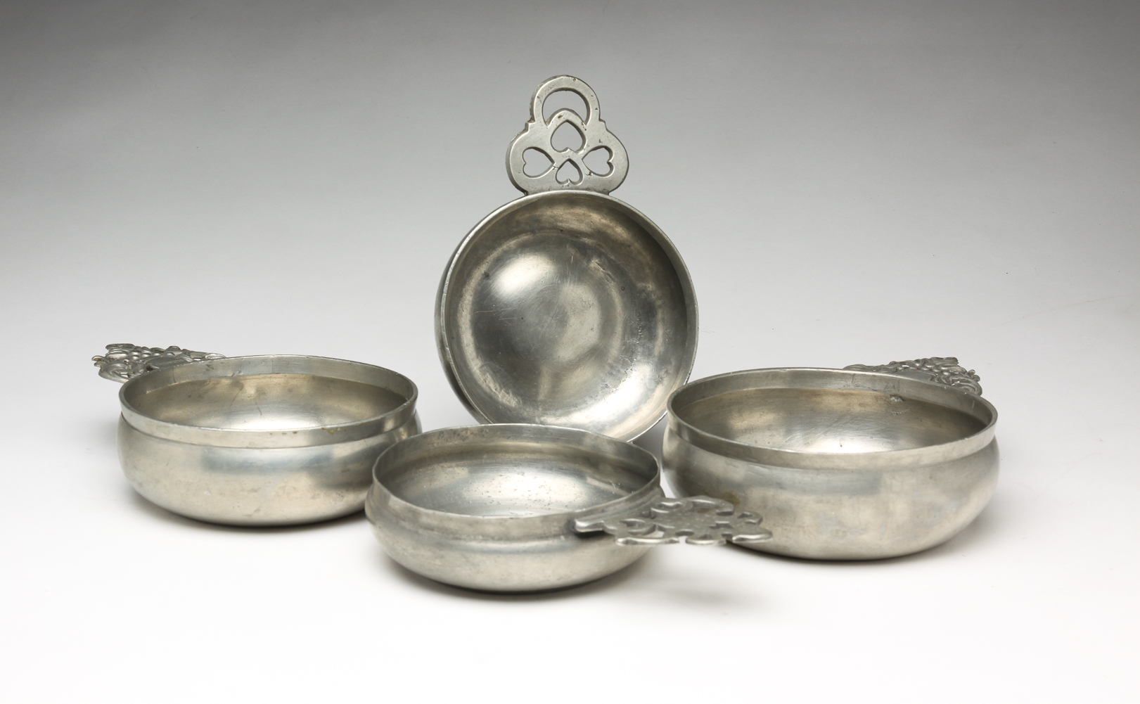 FOUR PEWTER PORRINGERS.