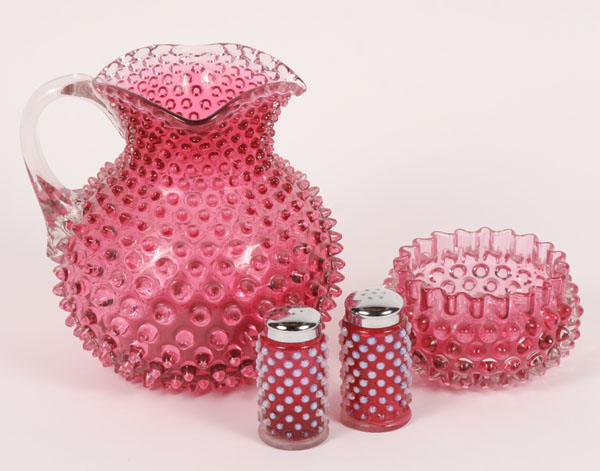 Four pieces cranberry glass;