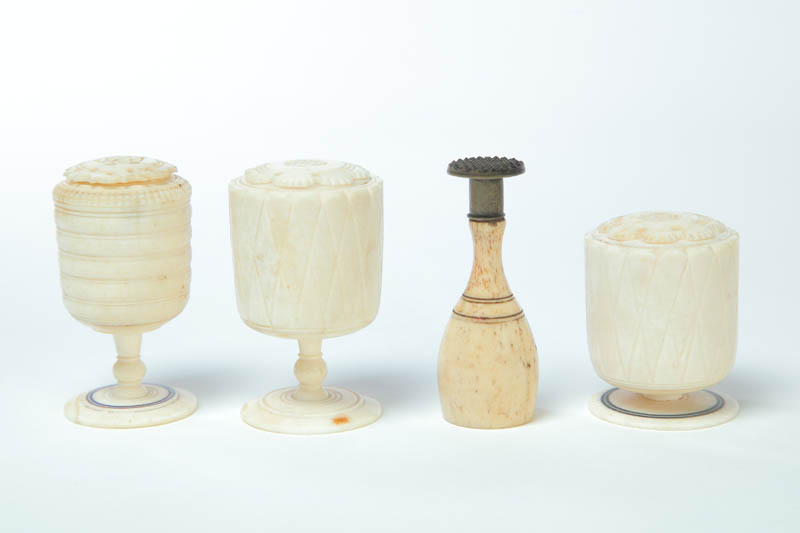 FOUR PIECES OF CARVED BONE AND