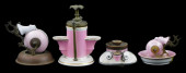 FOUR PINK CERAMIC INKWELLS WIT