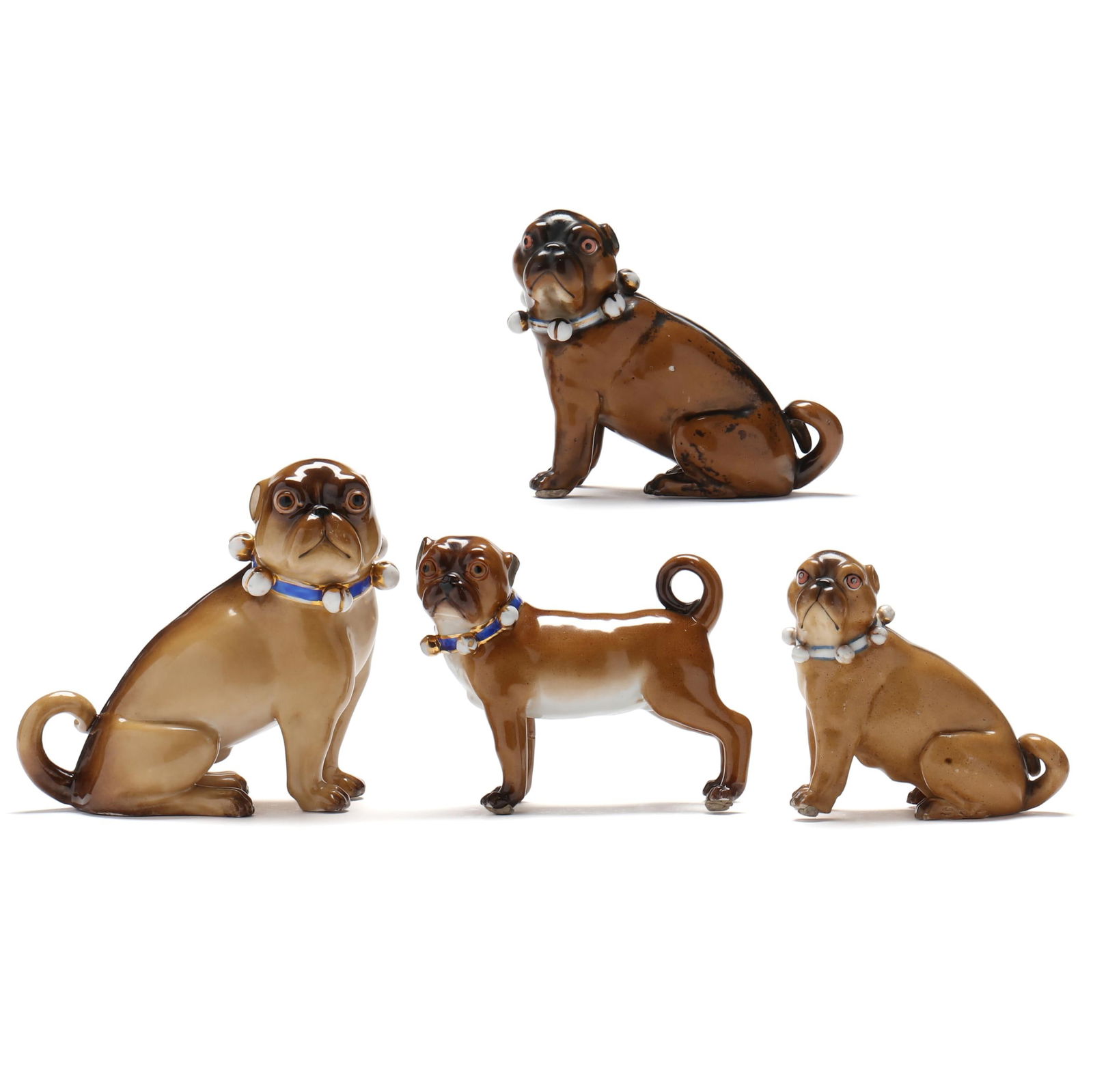 FOUR PORCELAIN PUG DOGSFour