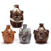 FOUR POTTERY FACE JUGS, FRED B