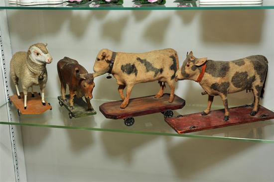FOUR PULL TOYS. Including two cows