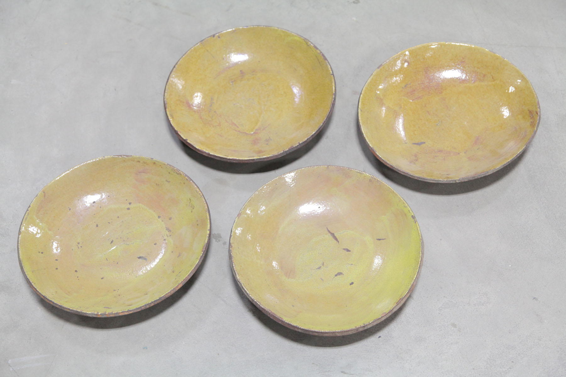 FOUR REDWARE PIE PLATES.  American