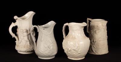 Four saltware jugs, decorated