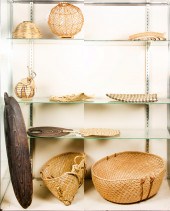 FOUR SHELVES OF ETHNOGRAPHIC A