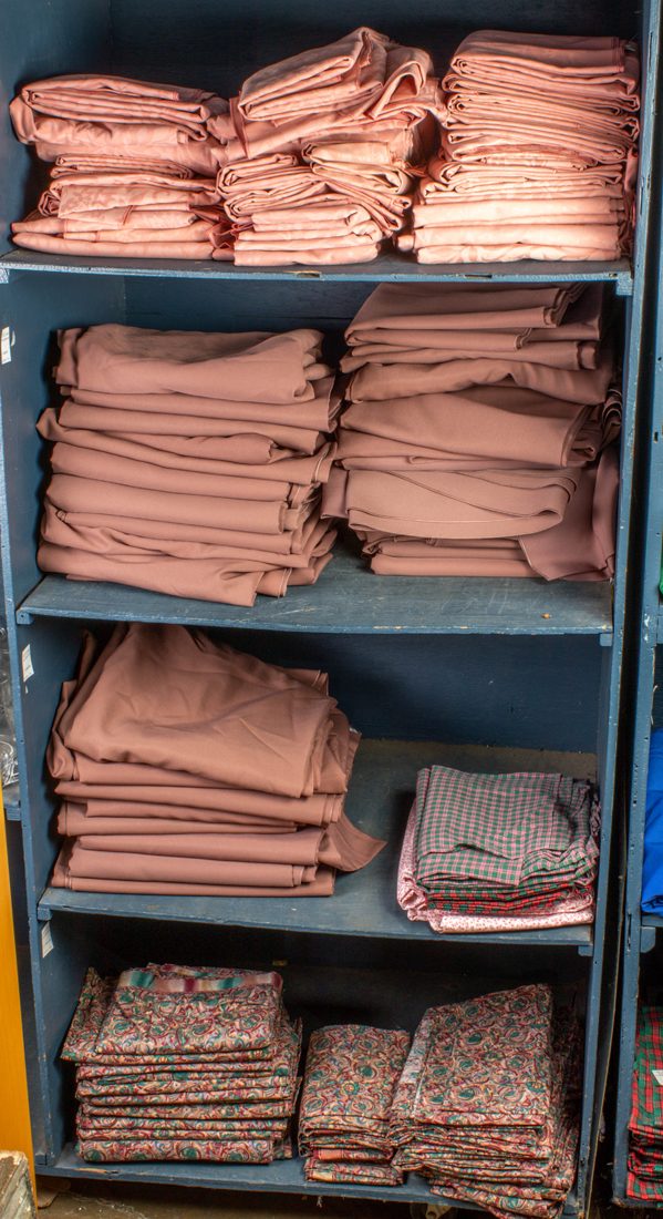 FOUR SHELVES OF TABLE LINENS Four
