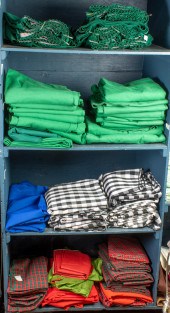 FOUR SHELVES OF TABLE LINENS F