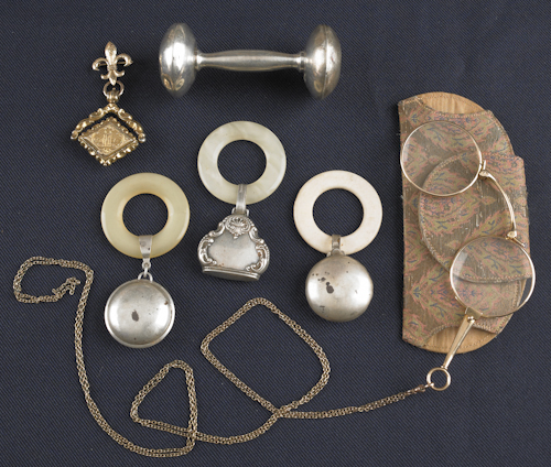 Four silver baby rattles together