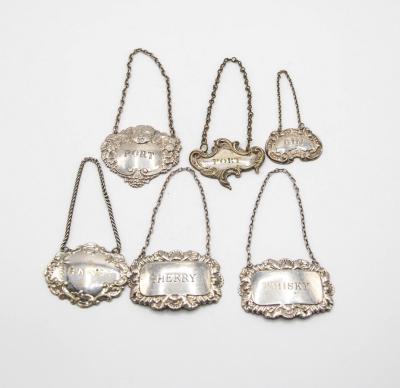 Four silver decanter labels,
