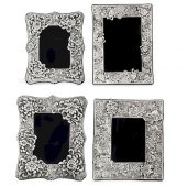 FOUR SILVER FLORAL DECORATED P