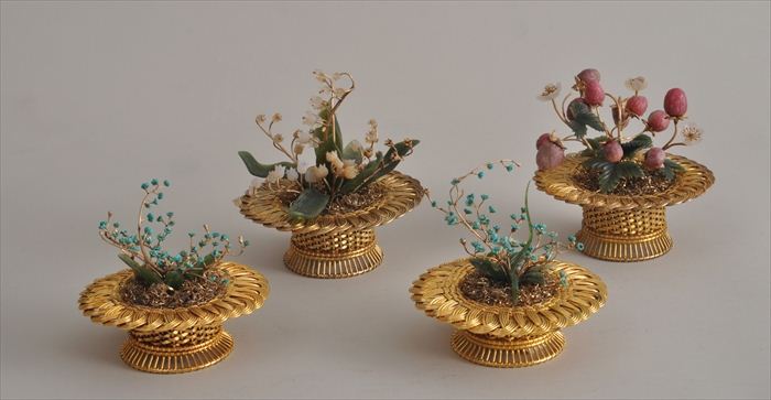 FOUR SILVER GILT BASKETS FILLED