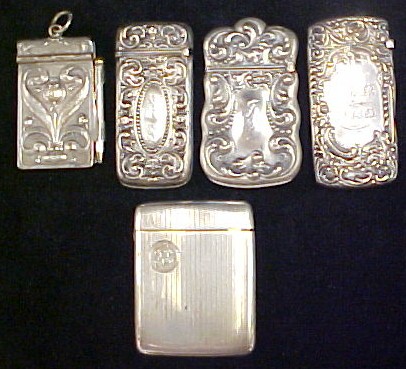 Four silver match safes  all