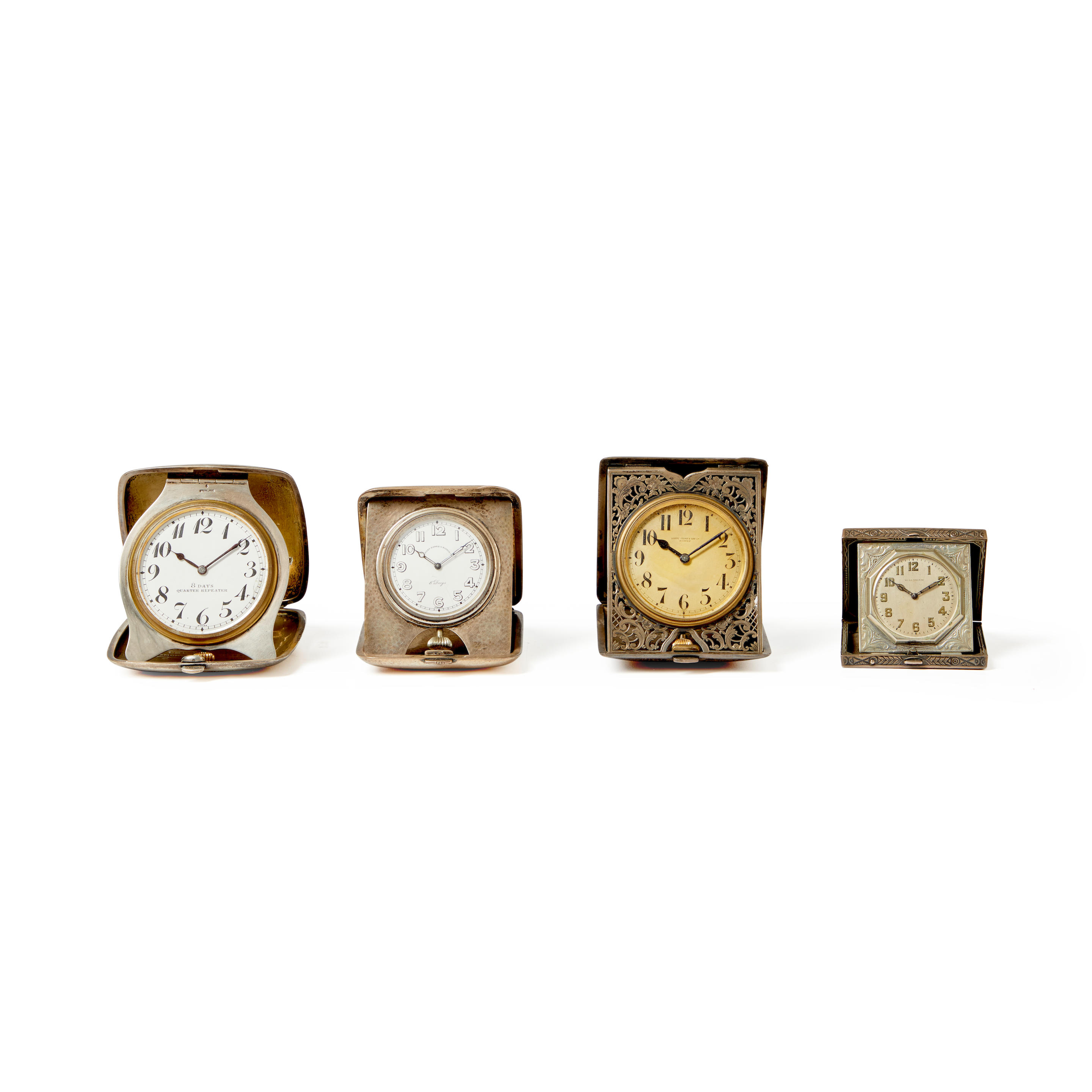 FOUR SILVER PORTABLE DESK CLOCKS
