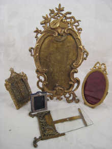 Four various brass picture frames