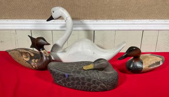 Four vintage decoys: a large