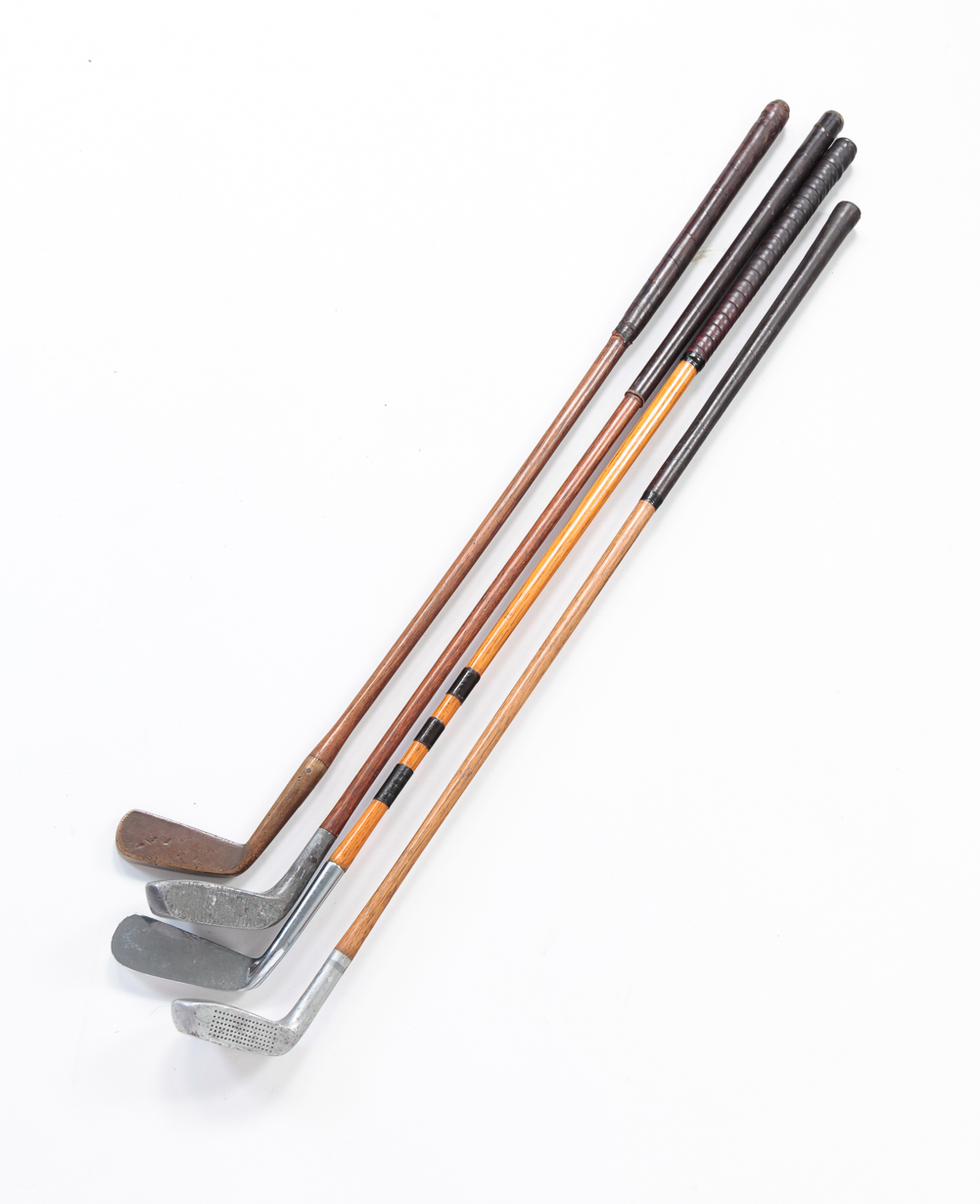 FOUR VINTAGE GOLF CLUBS.