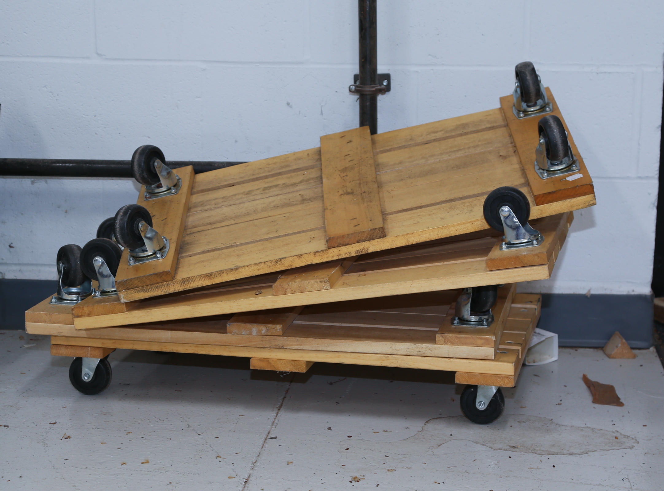 FOUR WOOD PLANK FURNITURE DOLLIES .