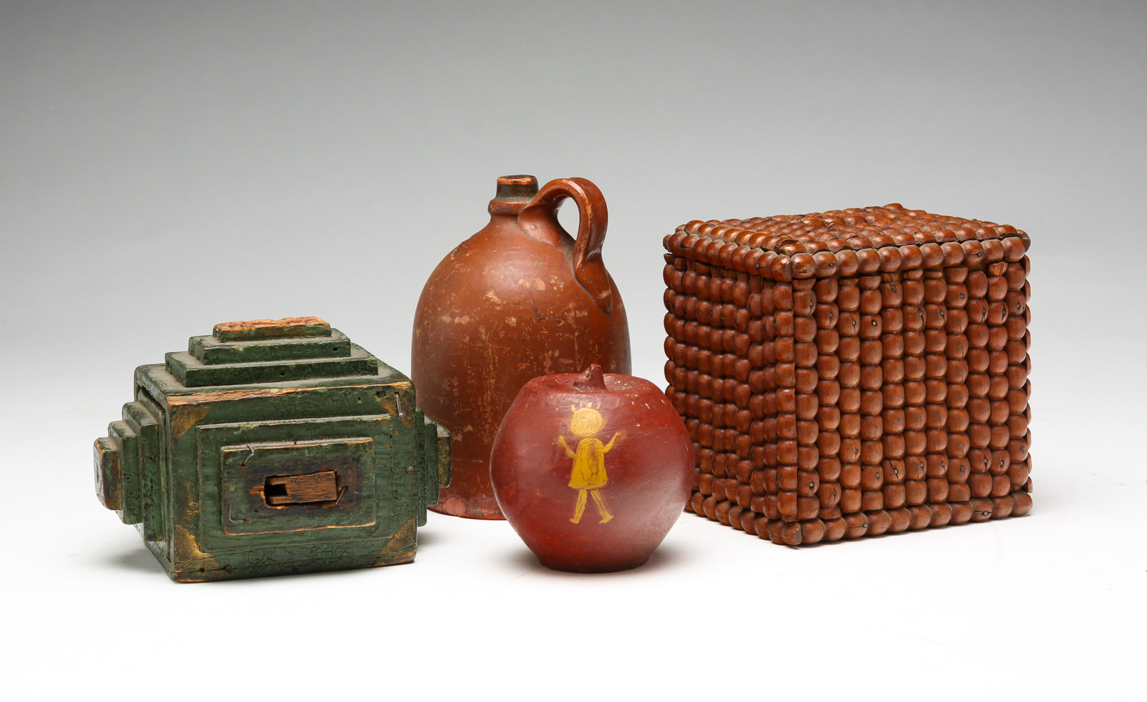 FOUR WOODEN AND POTTERY BANKS. Late