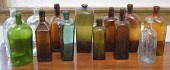 FOURTEEN ANTIQUE GLASS BOTTLE