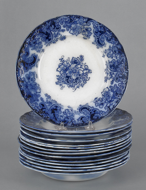 Fourteen flow blue plates and