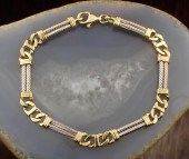FOURTEEN KARAT TWO-TONE GOLD B