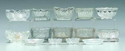 Fourteen pressed glass salts: