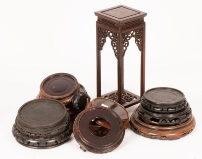 Fourteen wooden stands, the tallest