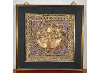Framed embroidery of deity, in gold