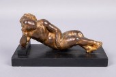 GILT-BRONZE FIGURE OF RECLININ