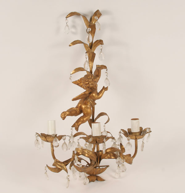 Gilt metal wall sconce with a