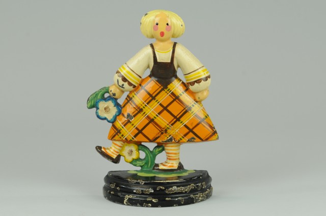 GIRL KICKING FLOWER DOORSTOP Very