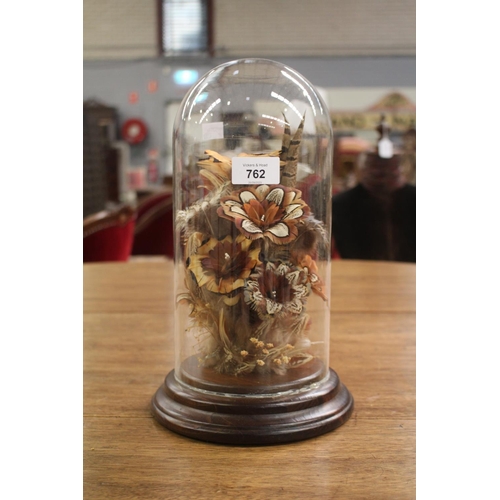 Glass dome with floral arrangement,