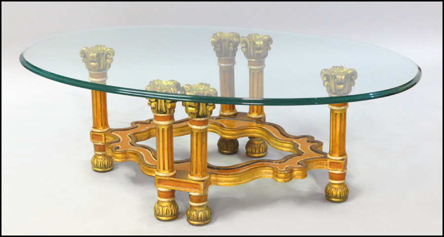 GLASS TOP TABLE. Raised on a