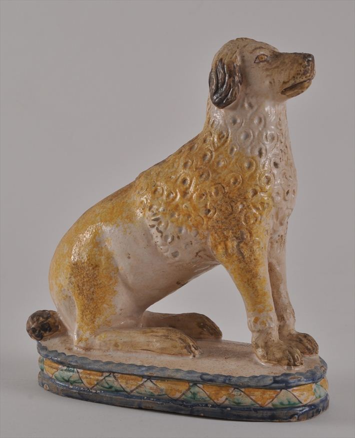 GLAZED POTTERY FIGURE OF A SEATED