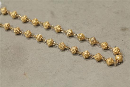 GOLD NECKLACE. Ornate beads with