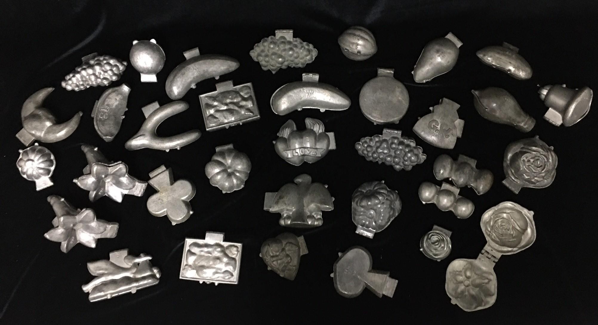 GROUP OF 34 PEWTER CHOCOLATE AND