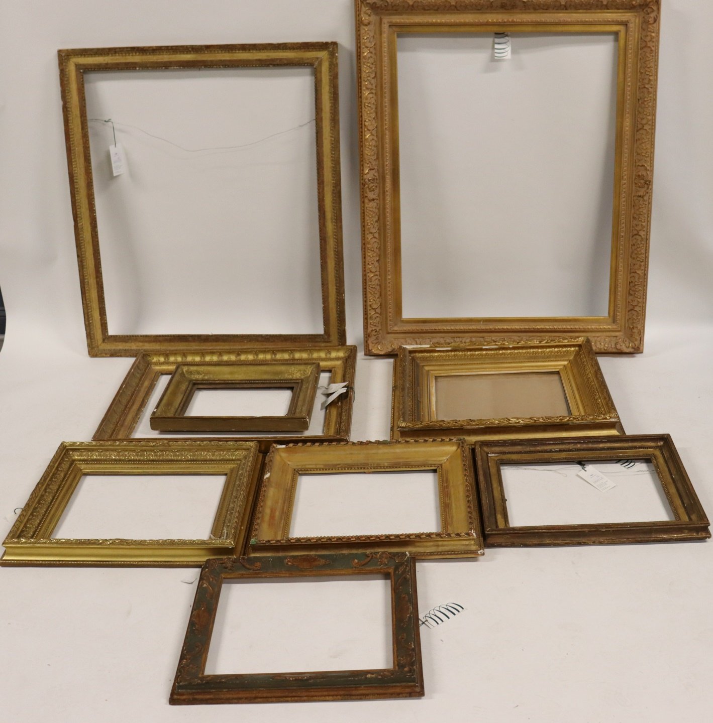 GROUP OF 9 ORNATE GILT WOOD FRAMES.