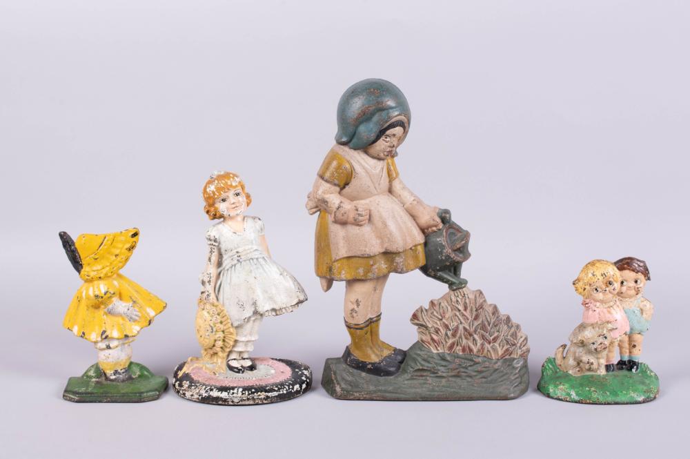 GROUP OF CAST IRON DOORSTOPS IN THE