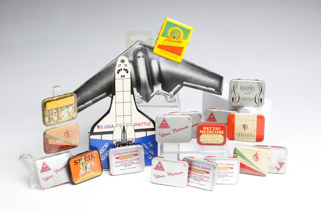 GROUP OF CONDOM TINS AND PACKAGING.