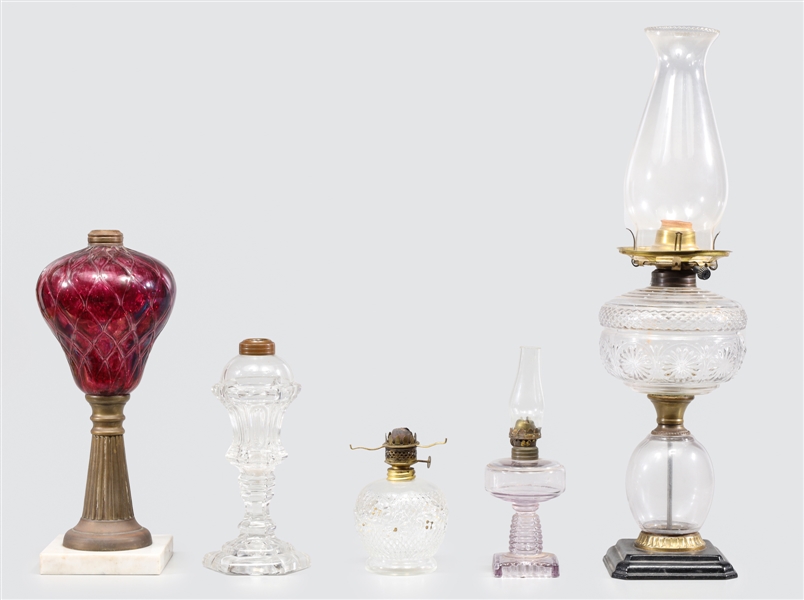 Group of five antique oil lamps and