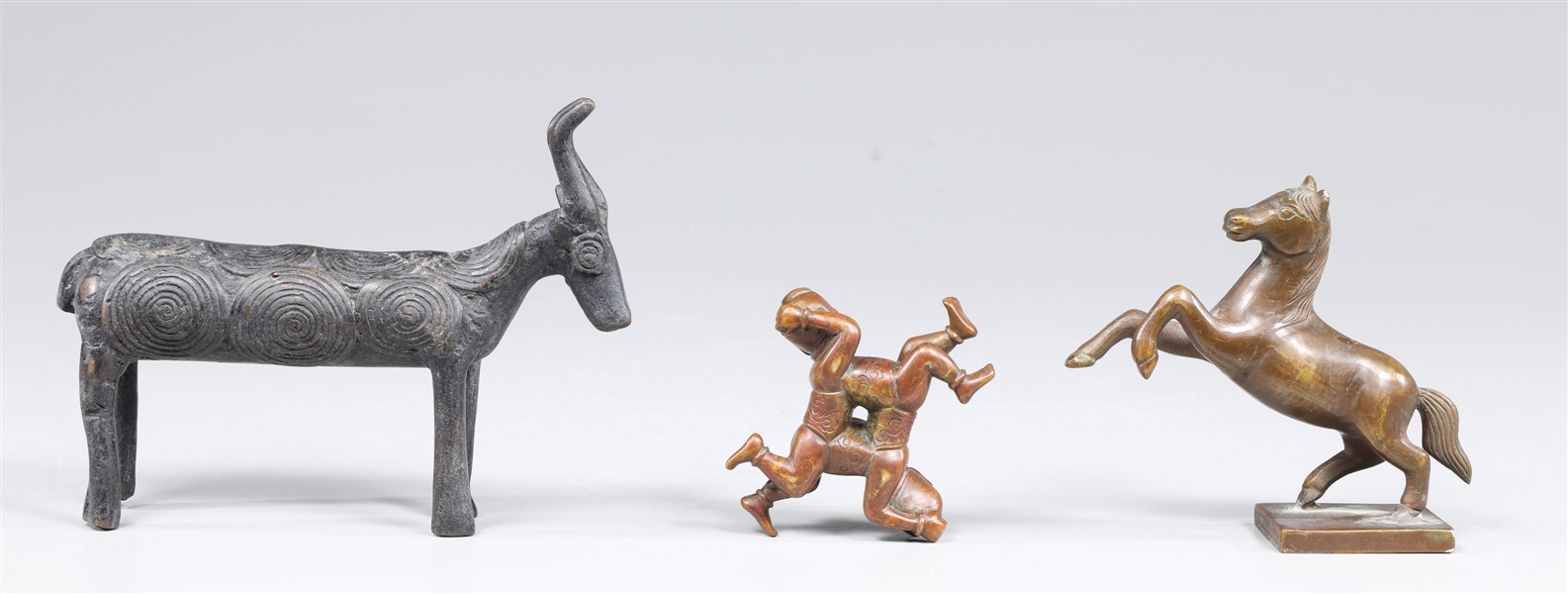 Group of three bronze figures,